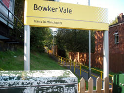Looking through the sign indicating the platform for trams to Manchester towards said platform